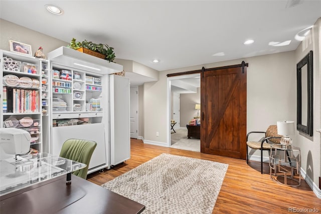 9957 Quintero St, Commerce City, CO 80022 - office with a barn door, wood finished floors, and recessed lighting