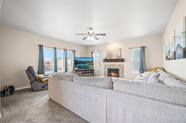 living room with a fireplace, carpet floors, and ceiling fan