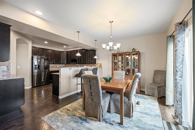 dining room featuring dark hardwood / wood-style floors and a chandelier