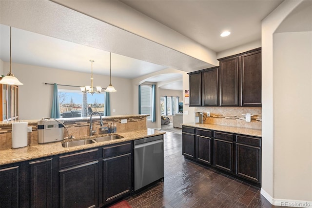 kitchen with sink, dark wood-type flooring, hanging light fixtures, and dishwasher