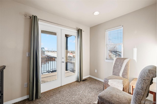 living area with french doors and carpet