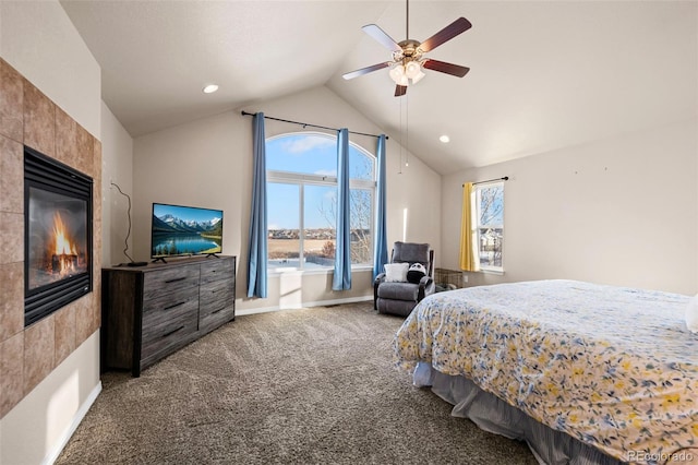 bedroom featuring a fireplace, vaulted ceiling, ceiling fan, and carpet flooring