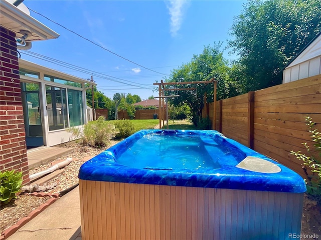 view of pool with a hot tub