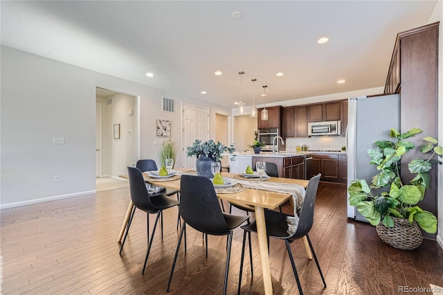 dining room featuring hardwood / wood-style flooring and sink