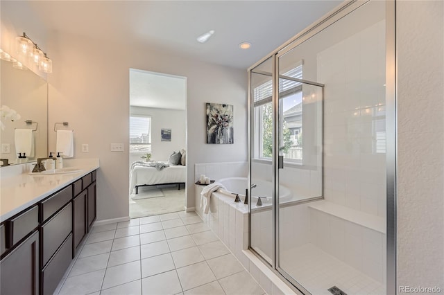 bathroom with tile patterned flooring, shower with separate bathtub, a healthy amount of sunlight, and vanity