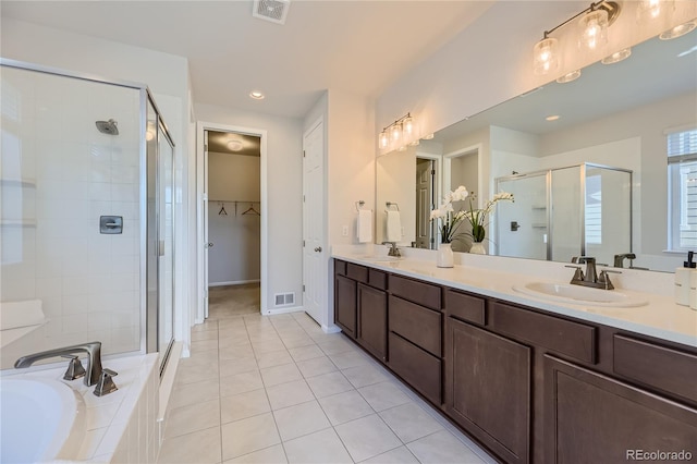 bathroom featuring vanity, tile patterned flooring, and separate shower and tub