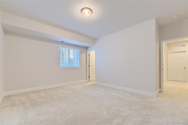 empty room with light colored carpet