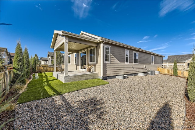 rear view of house with a lawn and a patio area