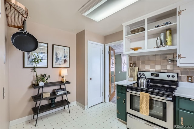 kitchen with electric range, green cabinetry, and decorative backsplash