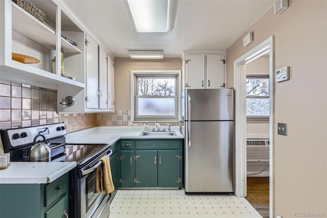 kitchen with appliances with stainless steel finishes, sink, a healthy amount of sunlight, green cabinetry, and decorative backsplash