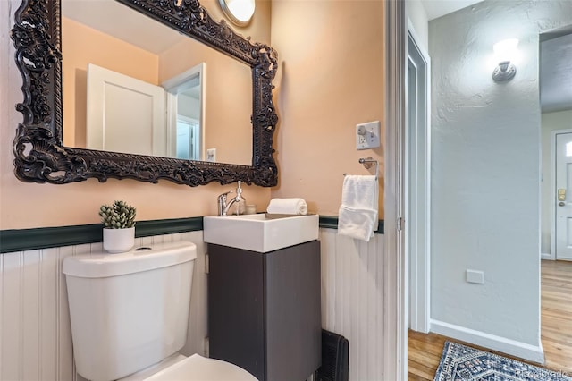 bathroom with sink, hardwood / wood-style flooring, and toilet