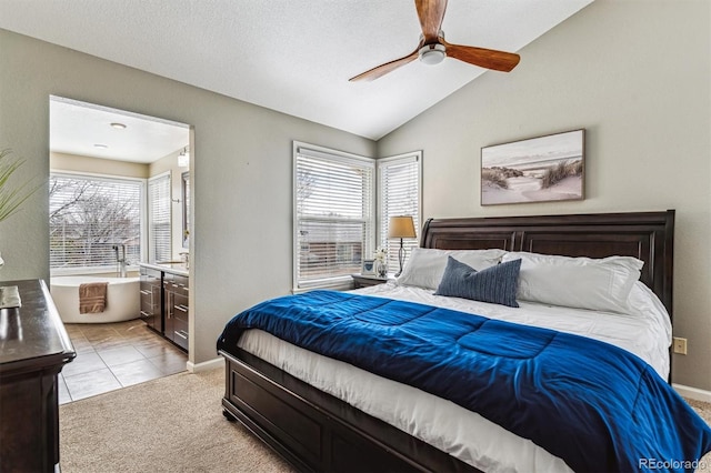 carpeted bedroom featuring multiple windows, vaulted ceiling, and ceiling fan