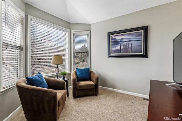 living area featuring lofted ceiling and light colored carpet