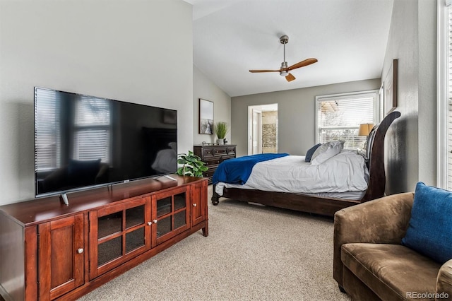 bedroom with vaulted ceiling and light colored carpet