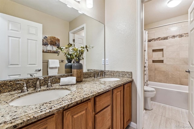 full bathroom with shower / tub combo with curtain, vanity, and toilet