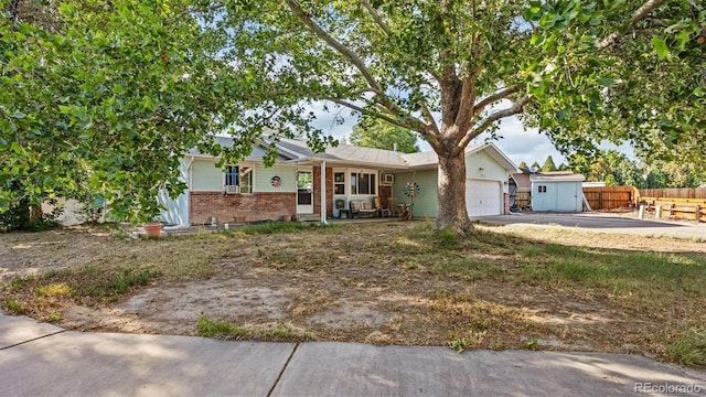 3102 Pine Cone Ct, Grand Junction, CO 81504 - single story home featuring brick siding, an attached garage, driveway, and covered porch
