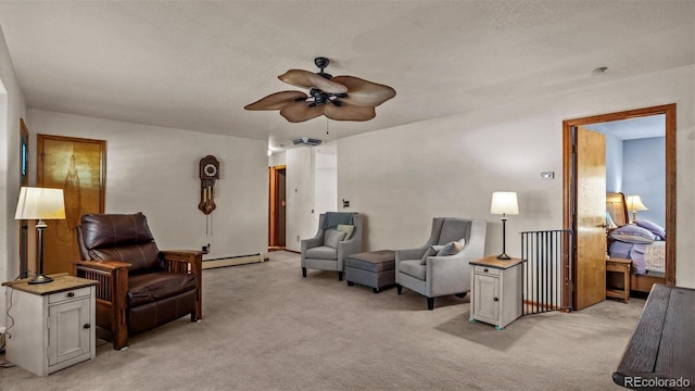 3102 Pine Cone Ct, Grand Junction, CO 81504 - sitting room featuring a baseboard heating unit, light carpet, and ceiling fan