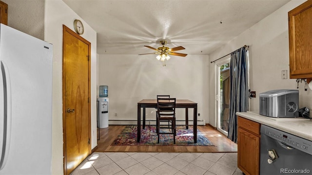 3102 Pine Cone Ct, Grand Junction, CO 81504 - kitchen with freestanding refrigerator, stainless steel dishwasher, light tile patterned floors, brown cabinets, and a ceiling fan