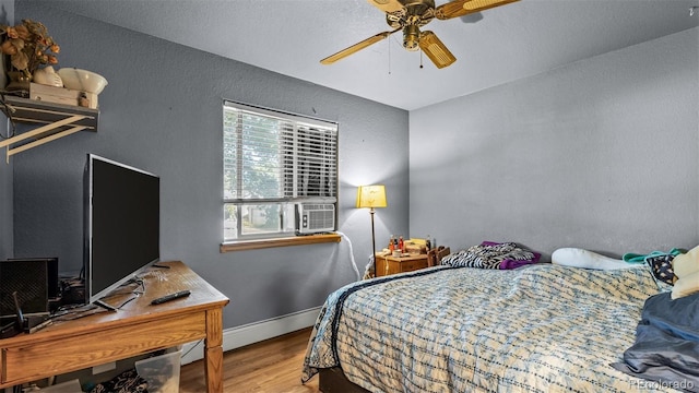 3102 Pine Cone Ct, Grand Junction, CO 81504 - bedroom featuring wood finished floors, a baseboard heating unit, a textured wall, baseboards, and ceiling fan