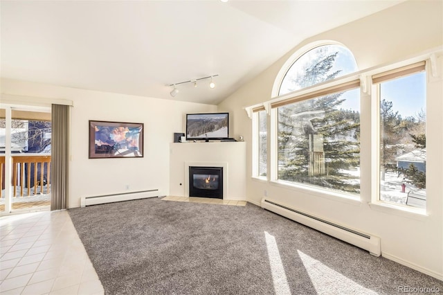 unfurnished living room featuring lofted ceiling, track lighting, light tile patterned flooring, and baseboard heating