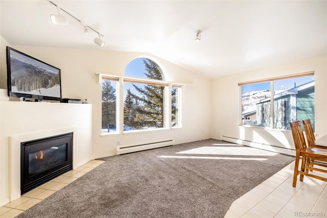 living room featuring baseboard heating, a fireplace, vaulted ceiling, and light carpet