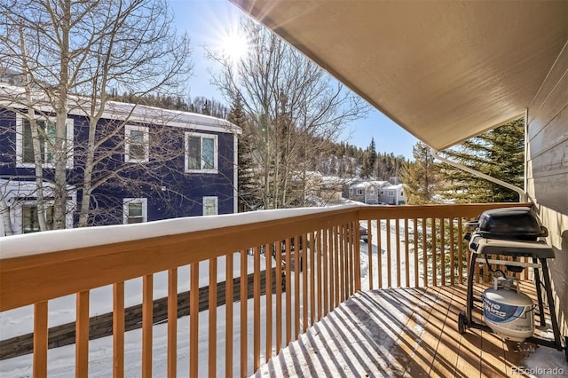 snow covered deck with grilling area