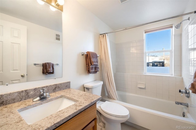 full bathroom with vanity, shower / tub combo, and toilet