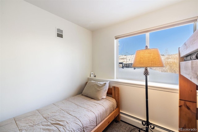 carpeted bedroom with a baseboard radiator