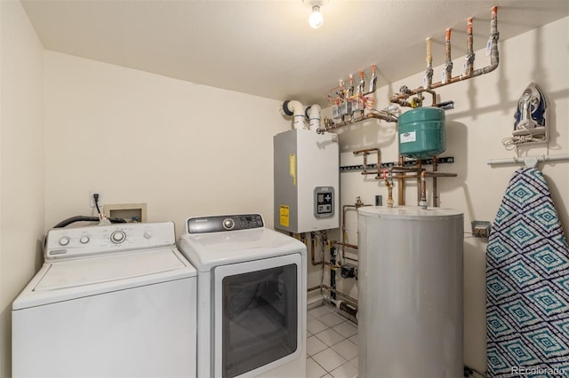 laundry room featuring independent washer and dryer, light tile patterned floors, and water heater