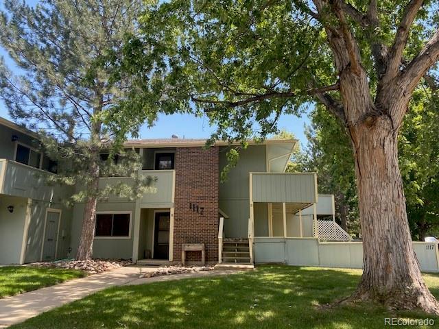 1117 Elysian Field Dr Unit B, Lafayette, CO 80026 - back of house featuring brick siding, a balcony, and a lawn