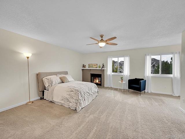 carpeted bedroom with a textured ceiling and ceiling fan