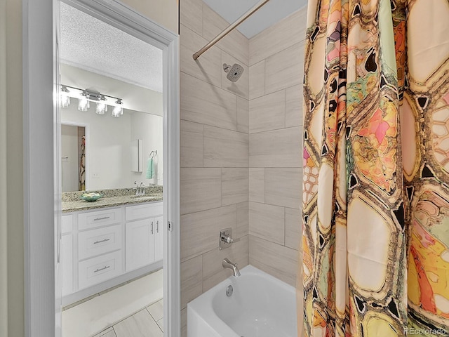 bathroom featuring vanity, a textured ceiling, tile patterned floors, and shower / tub combo