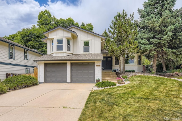 7727 Maroon Peak, Littleton, CO 80127 - split level home featuring an attached garage, board and batten siding, driveway, brick siding, and a front lawn