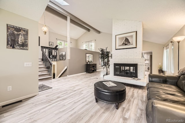 7727 Maroon Peak, Littleton, CO 80127 - living room with wood finished floors, a fireplace, stairs, and a skylight