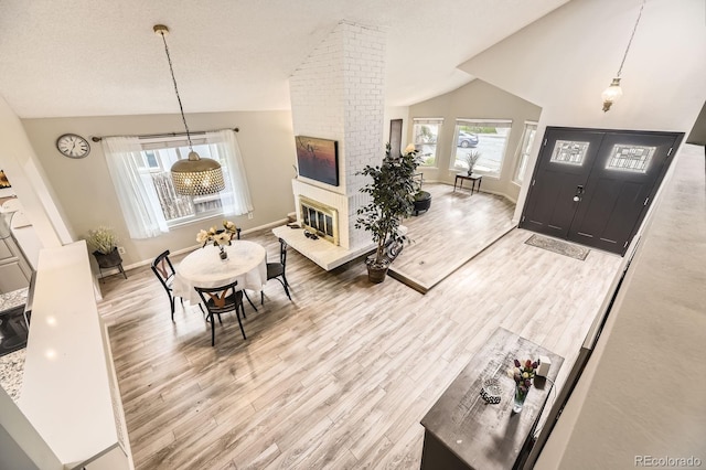 7727 Maroon Peak, Littleton, CO 80127 - foyer featuring lofted ceiling, wood finished floors, and a fireplace