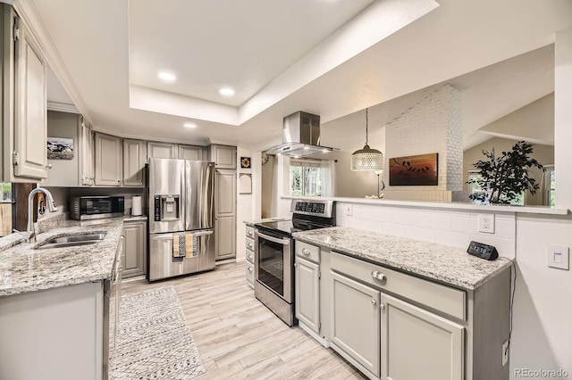 7727 Maroon Peak, Littleton, CO 80127 - kitchen with stainless steel appliances, island exhaust hood, light wood-style floors, recessed lighting, and light stone counters