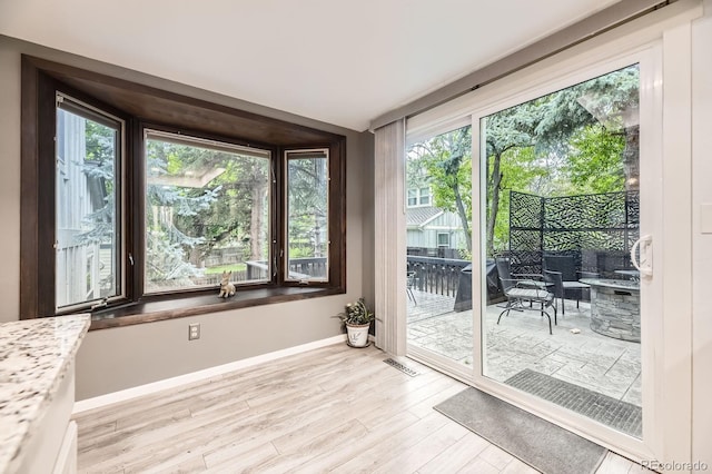 7727 Maroon Peak, Littleton, CO 80127 - unfurnished sunroom with wood finished floors and a deck