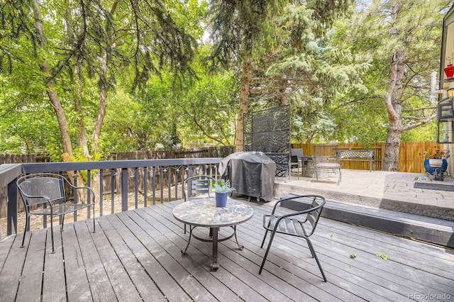 7727 Maroon Peak, Littleton, CO 80127 - wooden deck featuring a fenced backyard and a grill