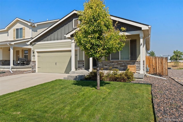 craftsman-style home featuring board and batten siding, stone siding, driveway, and a garage