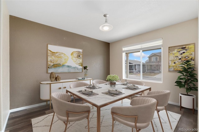 dining area with wood finished floors and baseboards