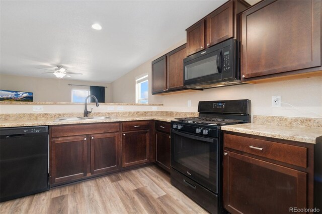 kitchen with black appliances, a sink, a ceiling fan, dark brown cabinets, and light wood-type flooring