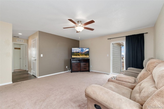 living area with ceiling fan, carpet flooring, and baseboards