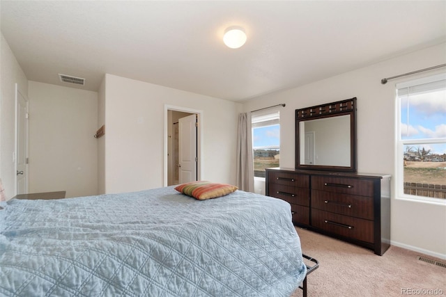 bedroom with light carpet and baseboards