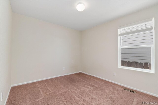 carpeted spare room with baseboards