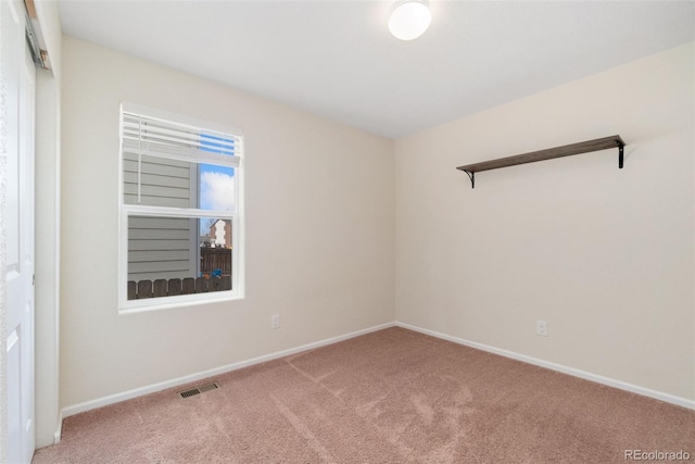 carpeted spare room with baseboards