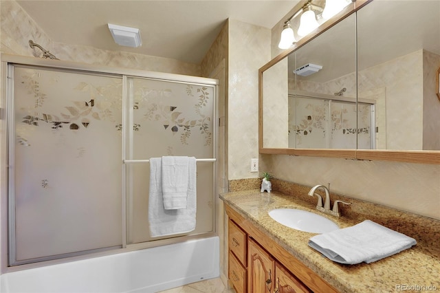 bathroom with vanity and shower / bath combination with glass door