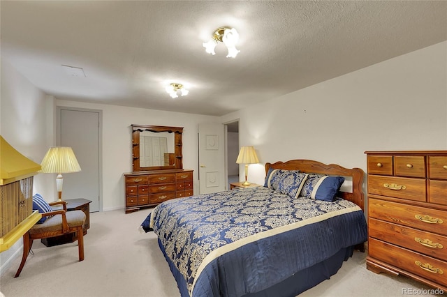 carpeted bedroom featuring a textured ceiling