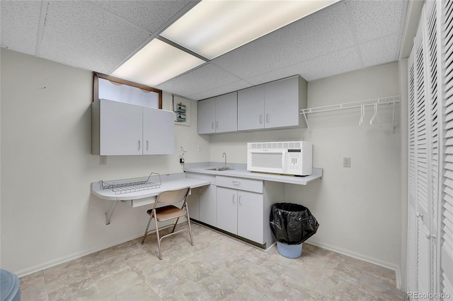 kitchen featuring sink and a drop ceiling