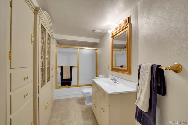 full bathroom with bath / shower combo with glass door, vanity, a textured ceiling, and toilet