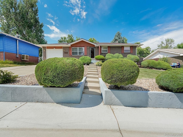 6769 W 70th Ave, Arvada, CO 80003 - single story home with brick siding, an attached garage, and driveway